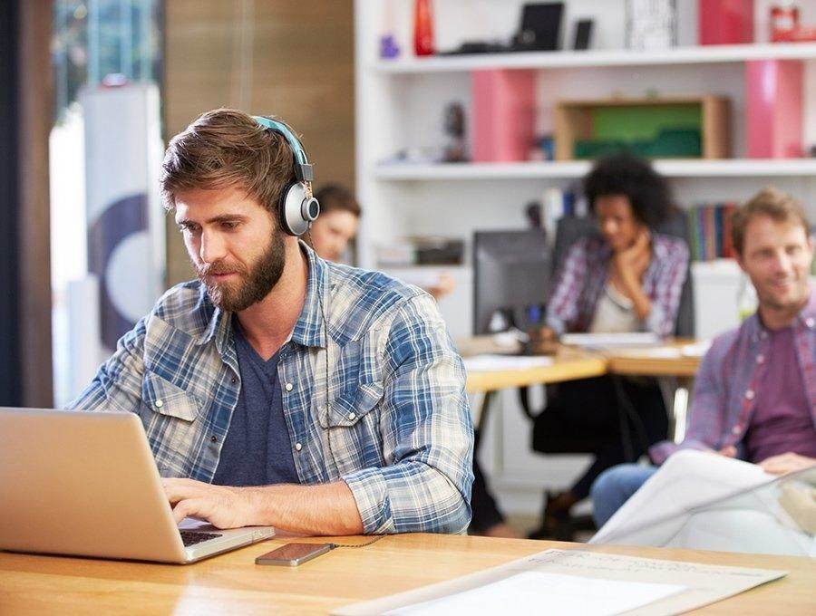 Student taking notes during IT training session